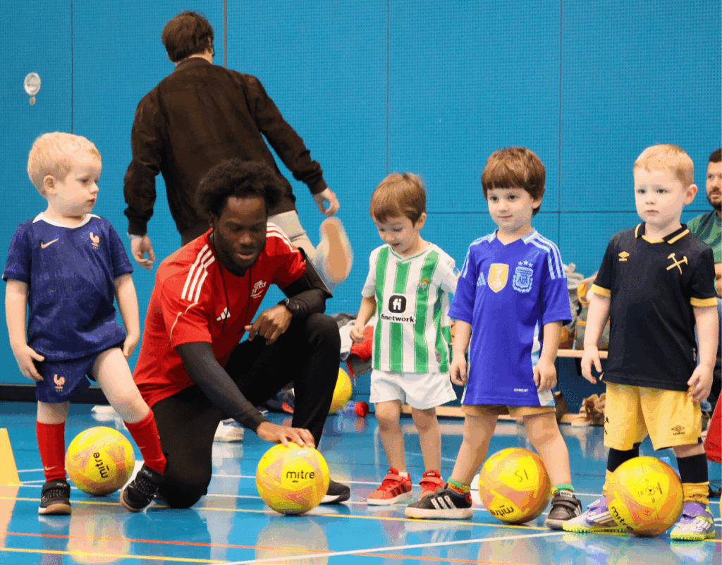 Children learning football skills with an InterSoccer coach at a Football Birthday Party