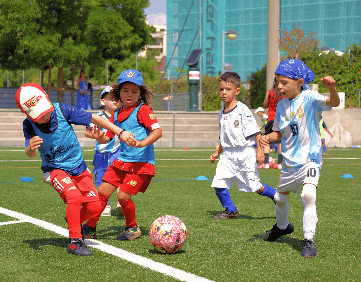 Children enjoying an InterSoccer Summer Football Camp match in a fun, active and inclusive outdoor environment.