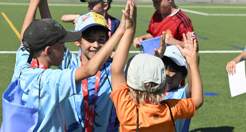Children celebrate at an InterSoccer Summer Football Camp during the World Cup Final offer.