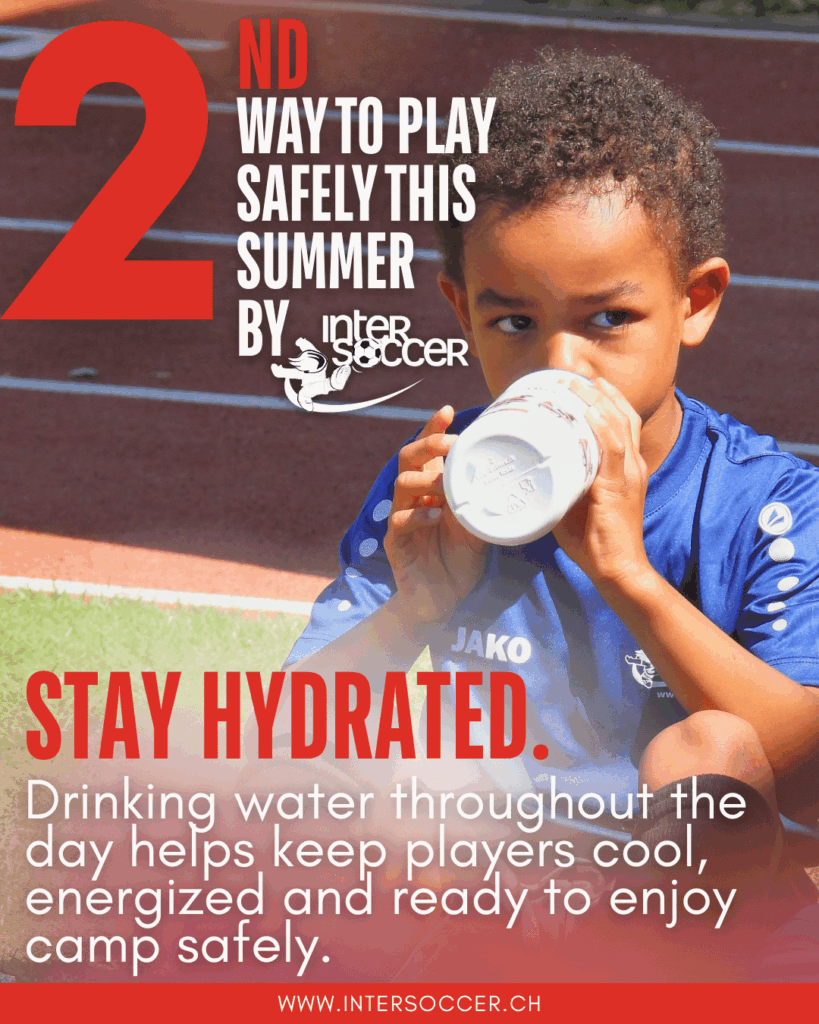 Young InterSoccer player drinking water during a summer football camp break.