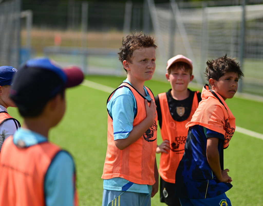 Young players listening instructions from coach during Intersoccer Autumn Camp