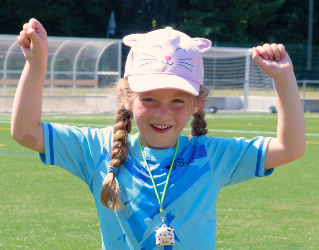 Girl celebrating during an InterSoccer football session in Geneva