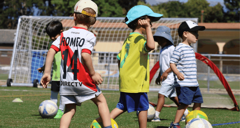 Young children playing football at an InterSoccer Autumn Mini Football Camp