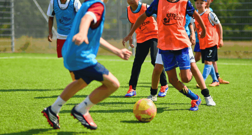 Children playing football together at InterSoccer Autumn Holiday Camps