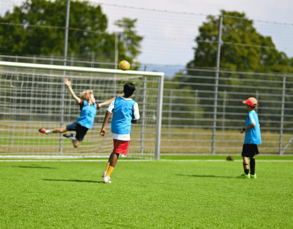Young goalkeeper catching the ball at an InterSoccer Autumn Holiday Camp