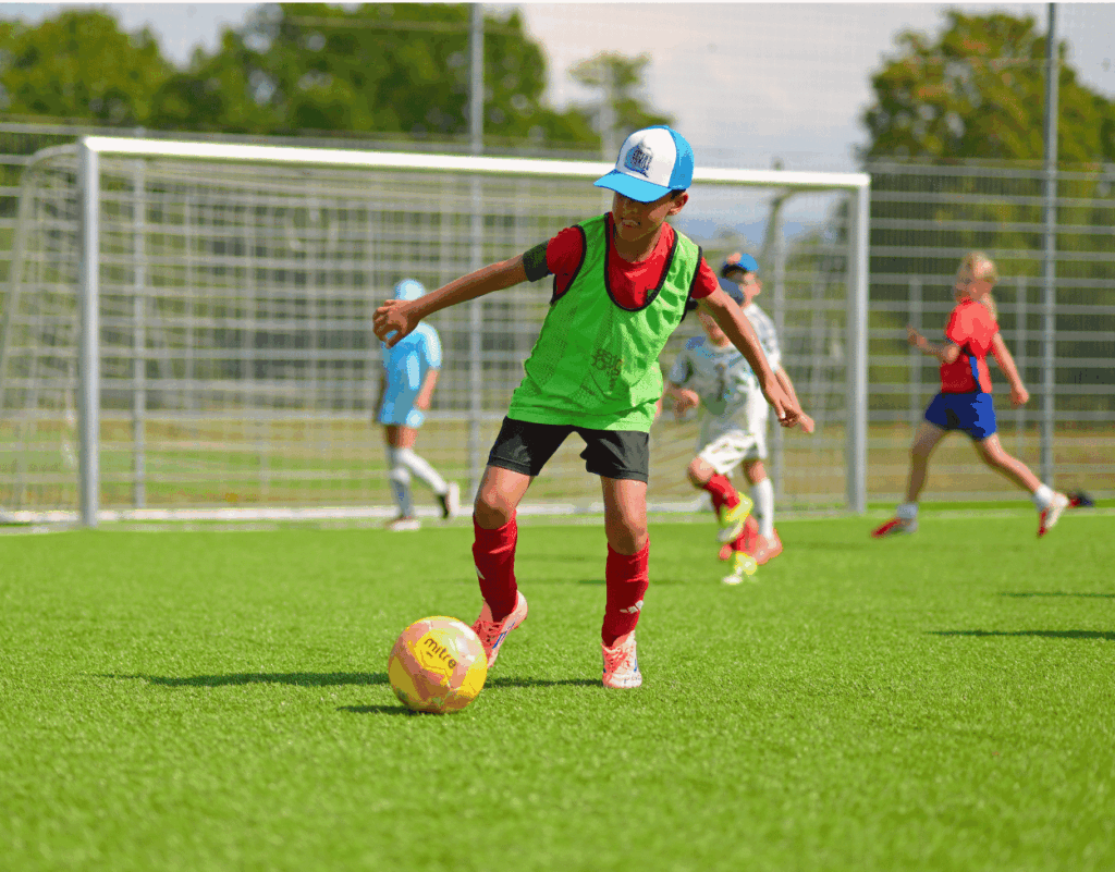 Child dribbling with the ball at an InterSoccer Autumn Holiday Camp