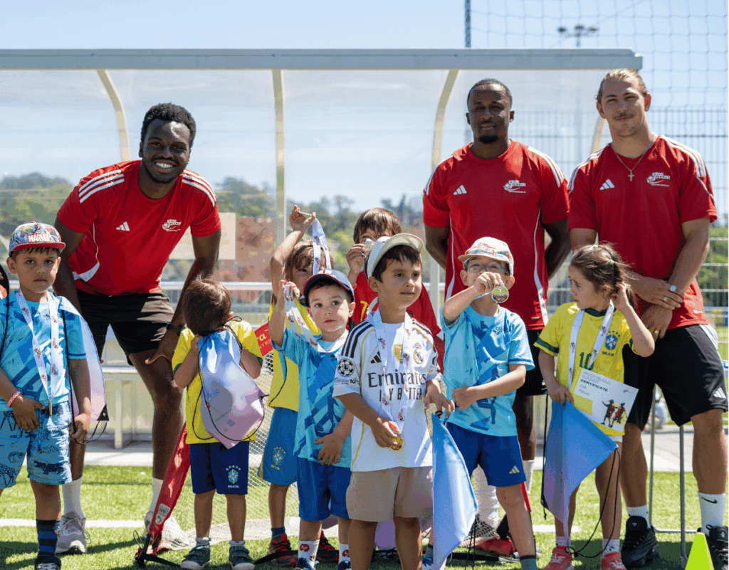 Little children and coaches together with medals at InterSoccer Autumn Mini Football Camp