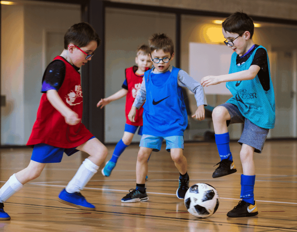 Children passing ball at InterSoccer Winter Indoor Football Course